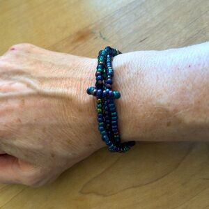 Stretchy triple band beaded bracelet in metallic blues & purples.